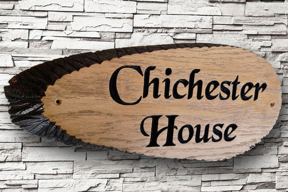 A personalized oak carved wooden house sign plaque by LD Trade, featuring live edges and crafted in the elegant Black Chancery font, displays 